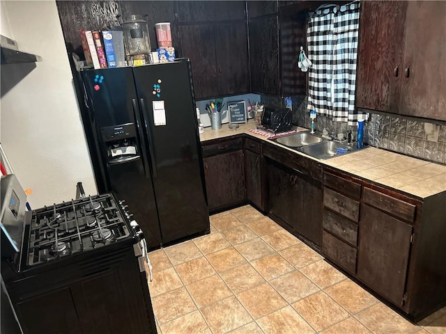 202 Coryell City Rd, Gatesville, TX 76528 - kitchen featuring a sink, dark brown cabinets, tile counters, and black refrigerator with ice dispenser