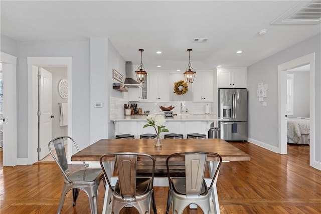dining space featuring visible vents, recessed lighting, baseboards, and wood finished floors