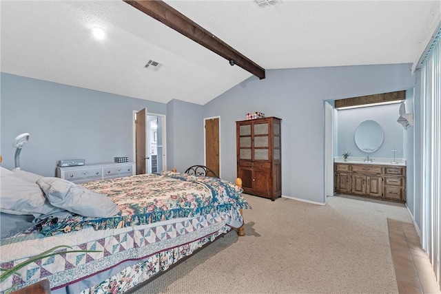 bedroom with visible vents, connected bathroom, vaulted ceiling with beams, baseboards, and light carpet