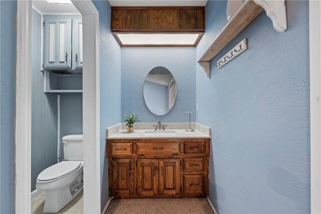 bathroom featuring toilet and vanity