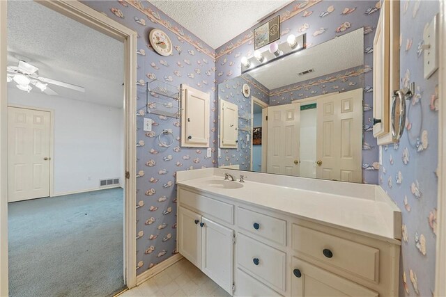 807 Birdie Ln, Lorena, TX 76655 - bathroom featuring wallpapered walls, a textured ceiling, vanity, baseboards, and a ceiling fan