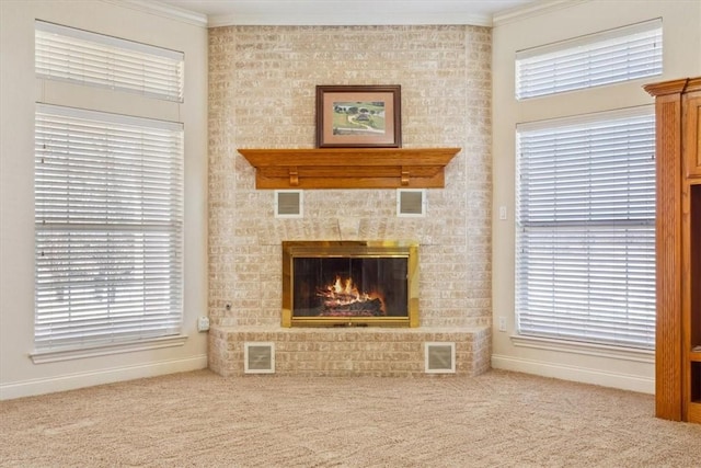 living area featuring visible vents, carpet, and crown molding