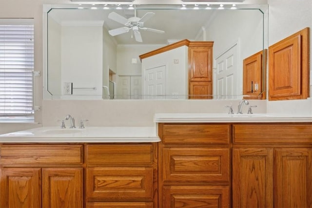 bathroom featuring double vanity, ceiling fan, crown molding, and a sink