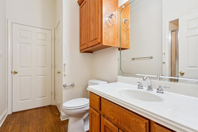 full bath featuring an enclosed shower, toilet, vanity, and wood finished floors