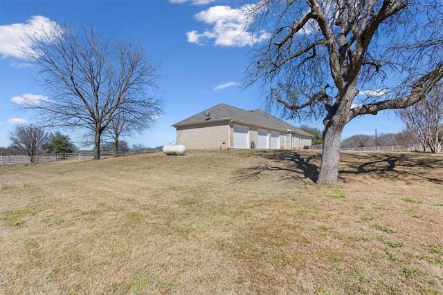 view of yard with a garage and fence