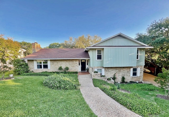 1016 Cardinal Dr, Woodway, TX 76712 - split level home featuring brick siding, a front lawn, a chimney, and a shingled roof