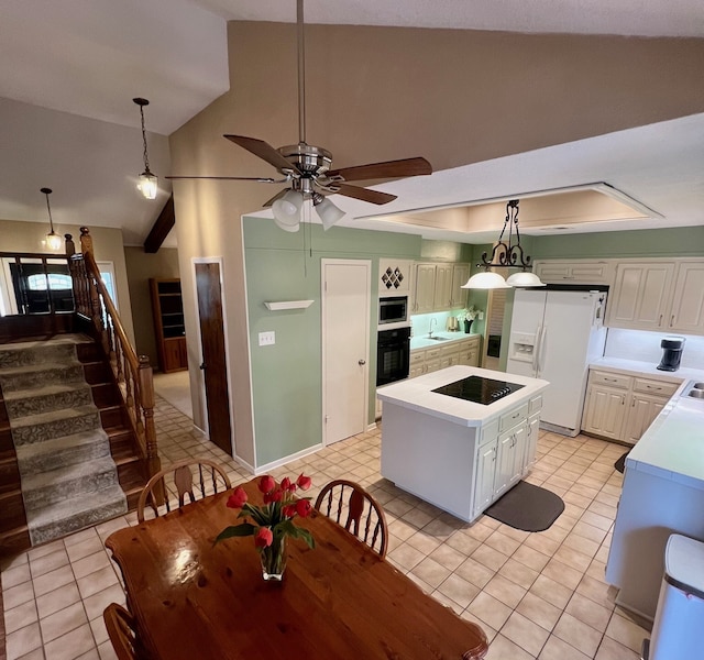 1016 Cardinal Dr, Woodway, TX 76712 - kitchen featuring black appliances, vaulted ceiling, light tile patterned floors, light countertops, and a ceiling fan