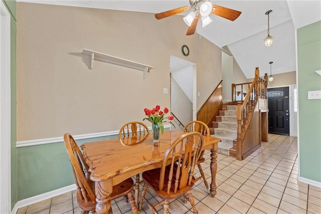 1016 Cardinal Dr, Woodway, TX 76712 - dining space featuring vaulted ceiling, stairway, light tile patterned floors, ceiling fan, and baseboards