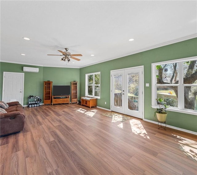 1016 Cardinal Dr, Woodway, TX 76712 - living area featuring french doors, healthy amount of natural light, wood finished floors, crown molding, and baseboards