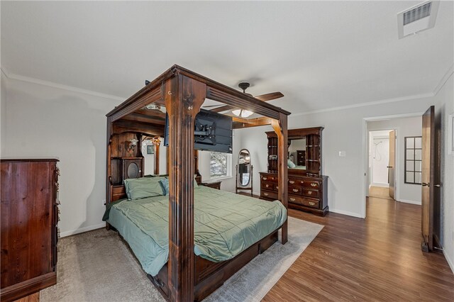 1016 Cardinal Dr, Woodway, TX 76712 - bedroom featuring baseboards, wood finished floors, ornamental molding, and ceiling fan