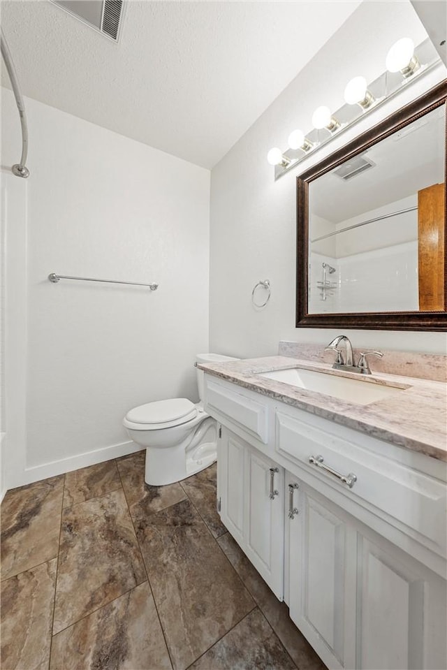 1016 Cardinal Dr, Woodway, TX 76712 - bathroom with vanity, toilet, a shower, and a textured ceiling