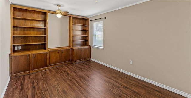 1016 Cardinal Dr, Woodway, TX 76712 - spare room featuring baseboards, dark wood-style flooring, ornamental molding, ceiling fan, and built in shelves