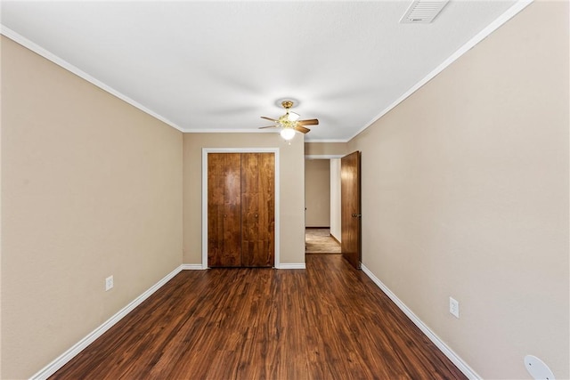 1016 Cardinal Dr, Woodway, TX 76712 - unfurnished bedroom featuring dark wood finished floors, baseboards, ornamental molding, and a ceiling fan