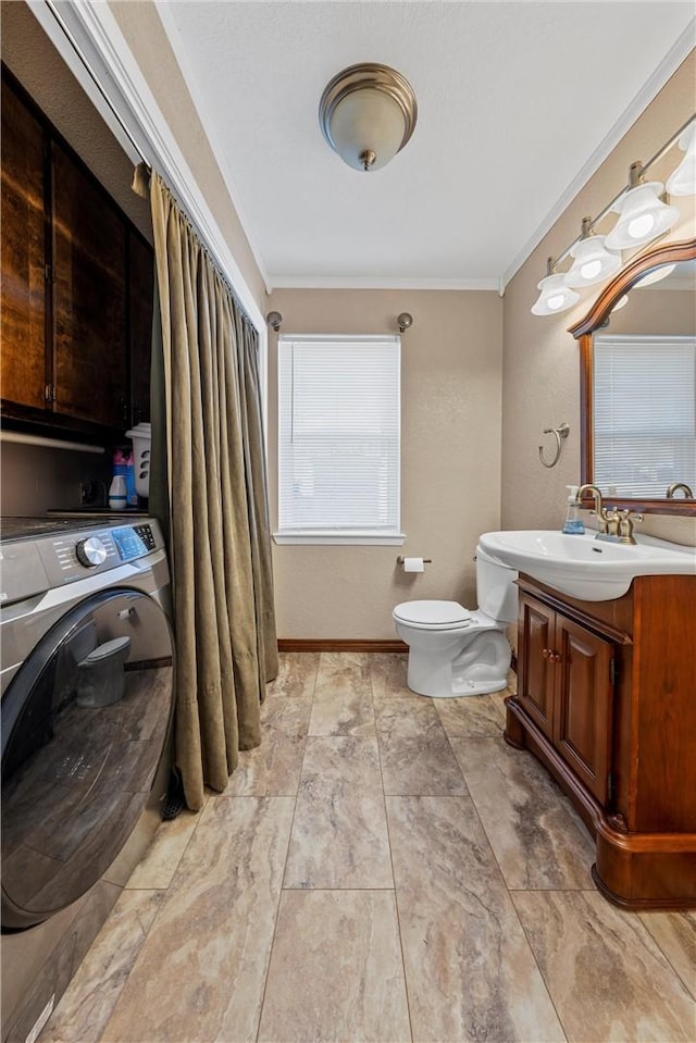 1016 Cardinal Dr, Woodway, TX 76712 - bathroom featuring washer / dryer, toilet, vanity, and ornamental molding