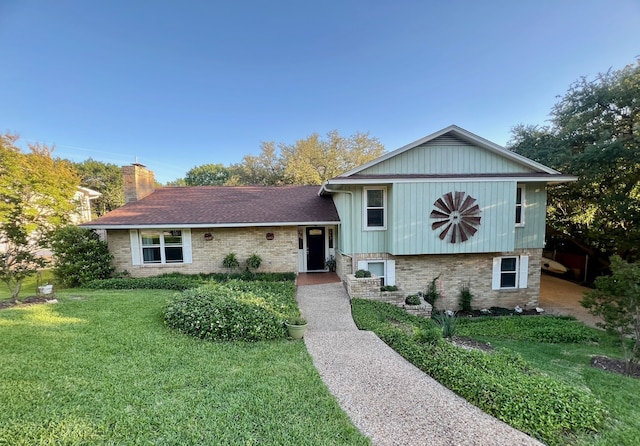 1016 Cardinal Dr, Woodway, TX 76712 - split level home featuring a front yard, brick siding, and a chimney