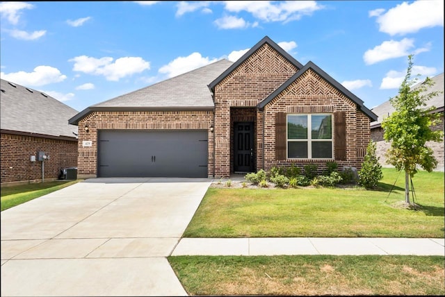 429 Cooper St, Argyle, TX 76226 - view of front of property featuring an attached garage, concrete driveway, a front lawn, and brick siding