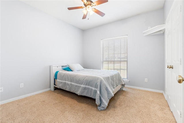 carpeted bedroom with baseboards and ceiling fan