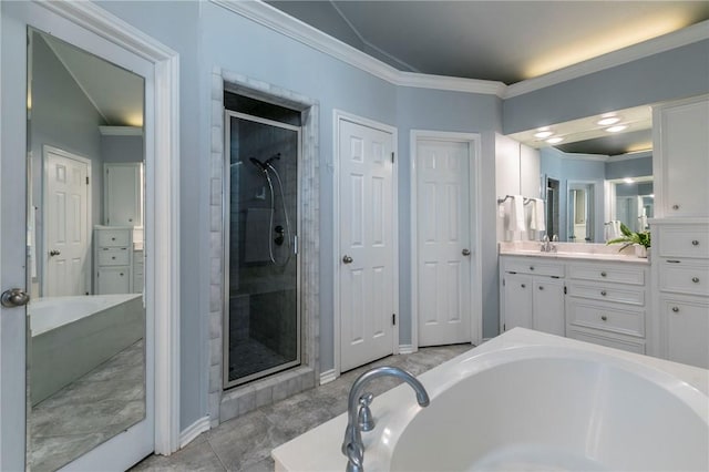 bathroom with vanity, baseboards, a stall shower, ornamental molding, and a garden tub