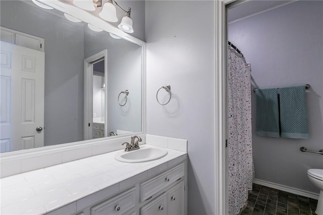 full bath featuring baseboards, toilet, and vanity