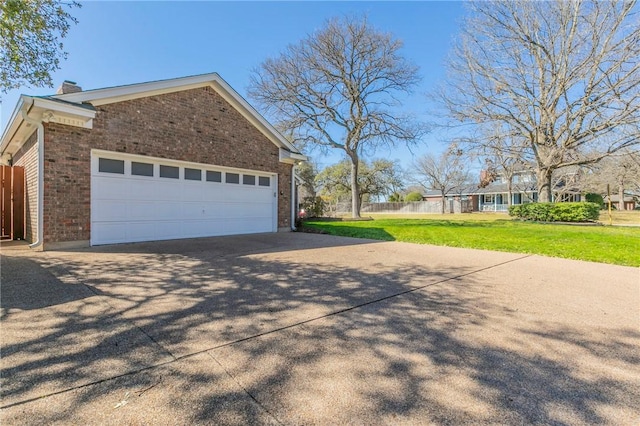 view of property exterior featuring brick siding, fence, concrete driveway, a lawn, and a garage