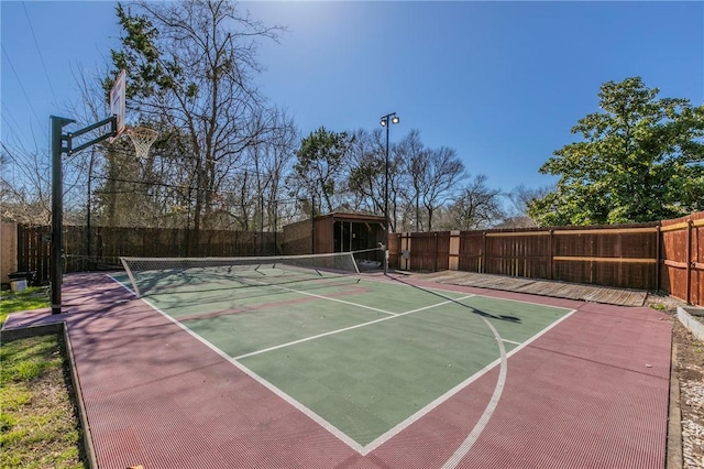 view of sport court with a tennis court, community basketball court, and fence