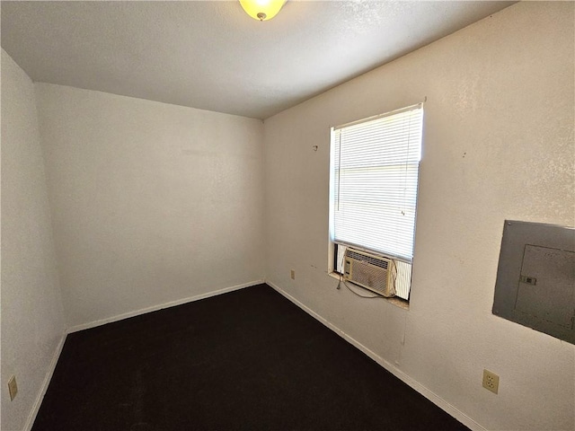 1596 Lcr 800, Groesbeck, TX 76642 - spare room with dark colored carpet, cooling unit, electric panel, and baseboards