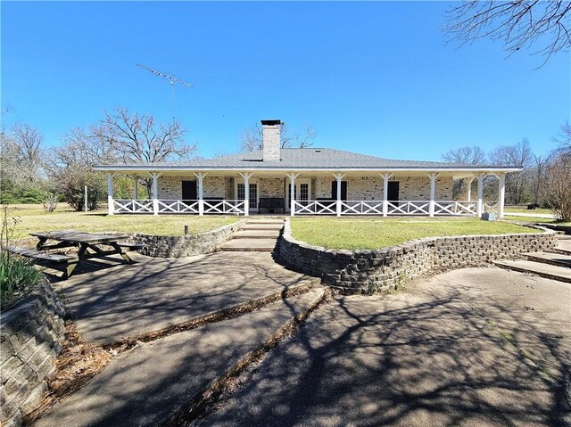 1596 Lcr 800, Groesbeck, TX 76642 - back of property with a porch, a lawn, and a chimney