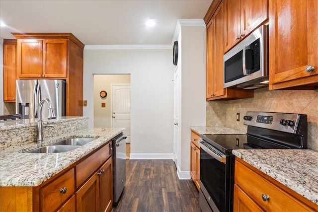 107 Indian Trails Rd, Riesel, TX 76682 - kitchen featuring a sink, appliances with stainless steel finishes, ornamental molding, and brown cabinetry