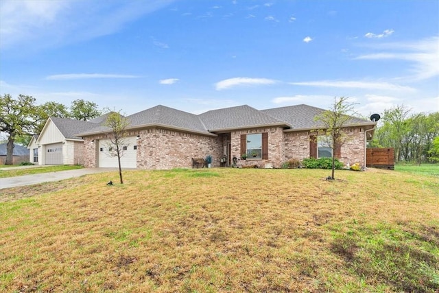 107 Indian Trails Rd, Riesel, TX 76682 - view of front facade with brick siding, a garage, a front lawn, and driveway
