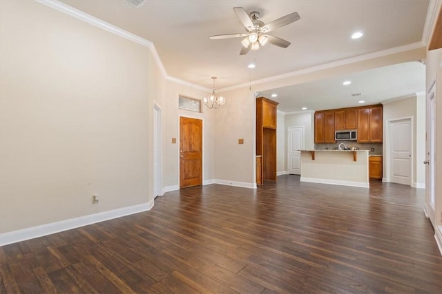 107 Indian Trails Rd, Riesel, TX 76682 - unfurnished living room with dark wood-type flooring, ceiling fan with notable chandelier, recessed lighting, crown molding, and baseboards