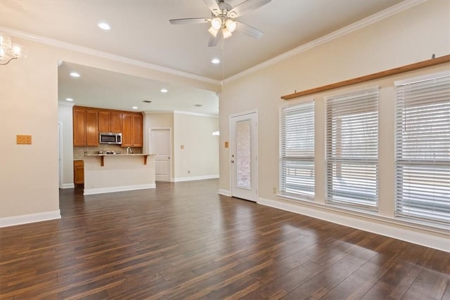 107 Indian Trails Rd, Riesel, TX 76682 - unfurnished living room featuring dark wood finished floors, ceiling fan with notable chandelier, crown molding, and baseboards