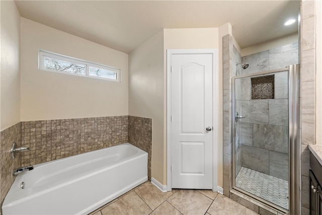 618 Powers St, Waco, TX 76705 - full bathroom featuring tile patterned floors, vanity, a garden tub, and a shower stall