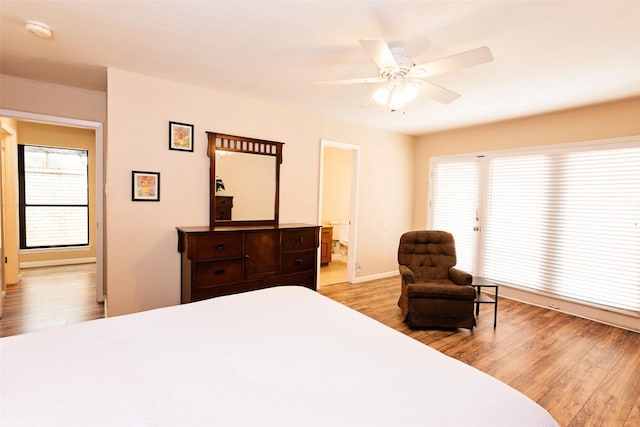 4020 River Oaks Cir, Temple, TX 76504 - bedroom with light wood finished floors, ensuite bathroom, baseboards, and ceiling fan