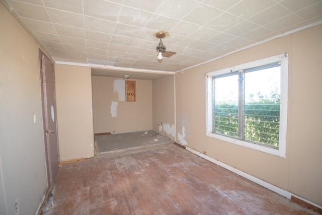 unfurnished room with wood finished floors