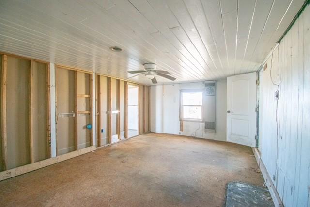 misc room with wooden ceiling and a ceiling fan