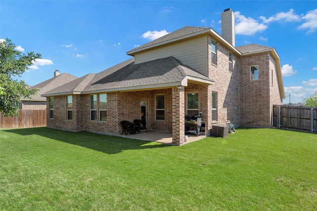 260 Oak Meadow Trl, Mcgregor, TX 76657 - rear view of property featuring a chimney, a patio area, brick siding, a shingled roof, and cooling unit