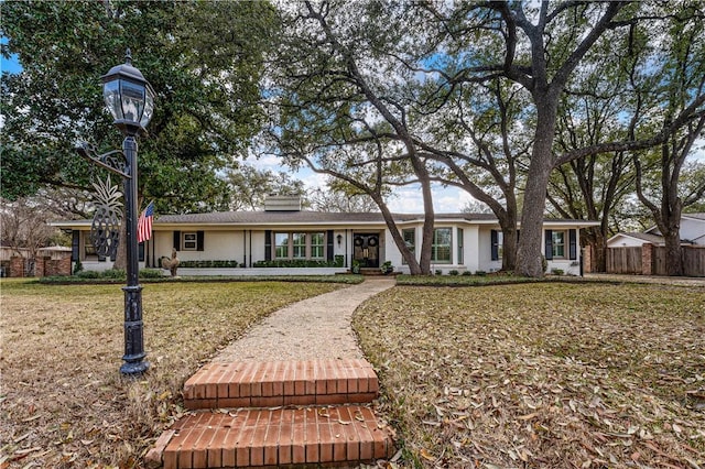 exterior space featuring fence and a lawn