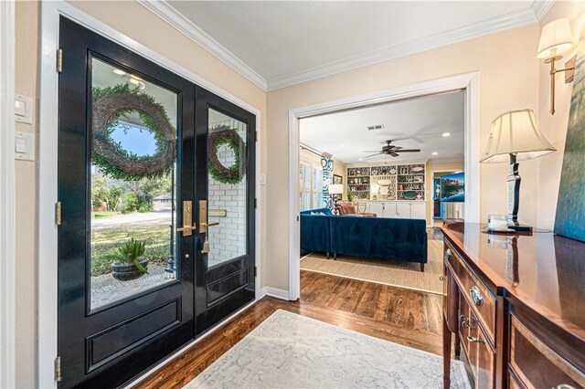 entrance foyer featuring visible vents, a ceiling fan, wood finished floors, french doors, and crown molding
