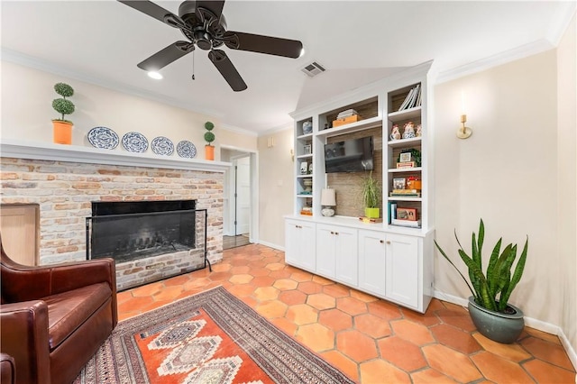 living area with a ceiling fan, baseboards, visible vents, a fireplace, and ornamental molding