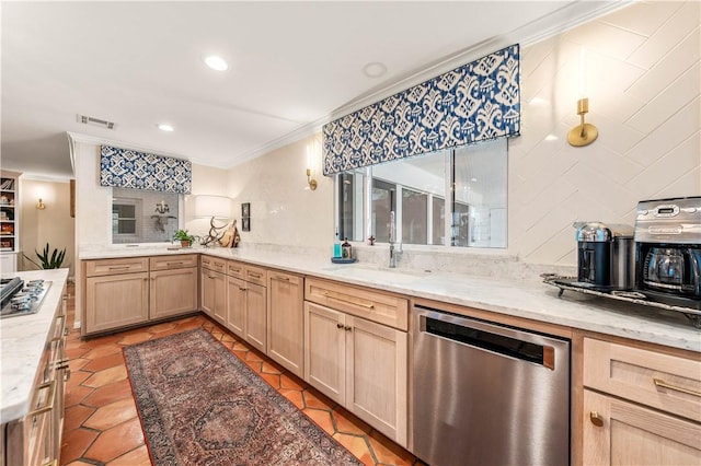 kitchen featuring visible vents, light brown cabinetry, ornamental molding, stainless steel appliances, and a sink