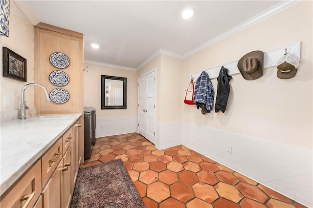 interior space with a sink, washer / clothes dryer, recessed lighting, crown molding, and tile patterned flooring