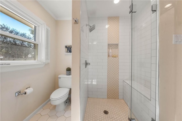 full bath featuring a shower stall, toilet, baseboards, and ornamental molding