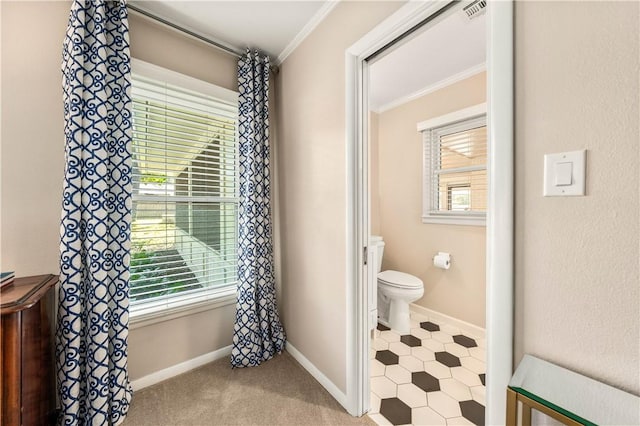 bathroom featuring visible vents, baseboards, toilet, and ornamental molding