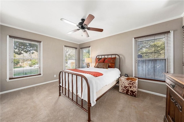 bedroom featuring baseboards, light carpet, ceiling fan, and crown molding