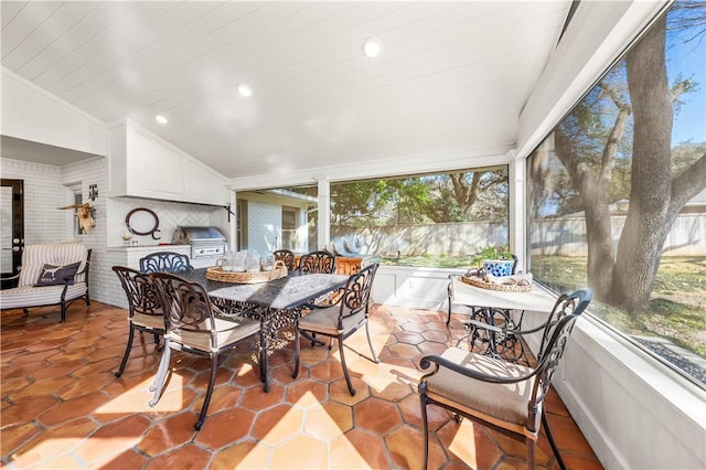 sunroom / solarium featuring a healthy amount of sunlight and outdoor dining space