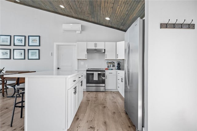 kitchen with white cabinetry, appliances with stainless steel finishes, a center island, under cabinet range hood, and a wall mounted air conditioner
