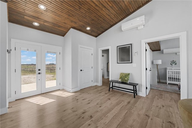 interior space featuring lofted ceiling, wooden ceiling, a wall unit AC, and french doors