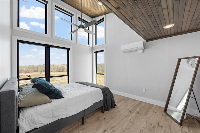 bedroom featuring wood ceiling, a wall unit AC, baseboards, recessed lighting, and light wood finished floors
