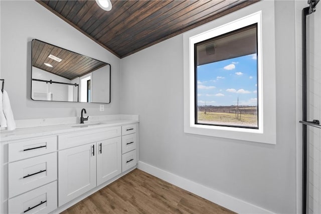 bathroom with vanity, lofted ceiling, baseboards, wood ceiling, and wood finished floors