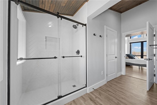 ensuite bathroom with wooden ceiling, a stall shower, and wood finished floors